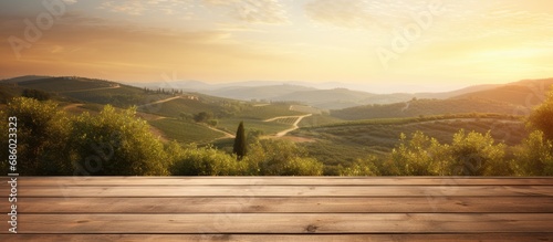 Sunrise over Tuscan vineyard, empty wooden table. photo