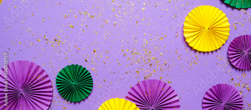 Mardi gras.Holidays mardi gras masquarade  venetian mask  fan over purple background. view  above mardi gras background copy space Happy Mardi Gras . Fat Tuesday carnival texture golden green purple