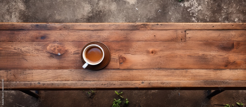 Top-down view of rustic bench with coffee cup, capturing still life details. Top-down view of rustic bench with coffee cup, capturing still life details.