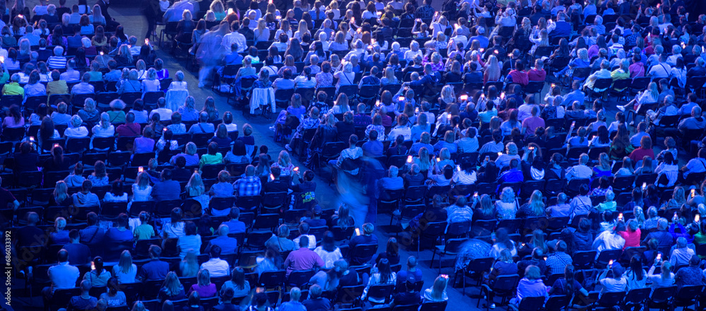 crowd of people at a concert in a huge concert hall crowd of people at a concert in a huge concert hall