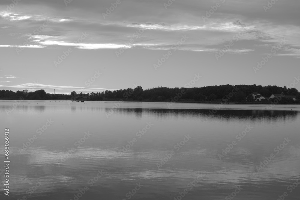 Black and white landscape with a lake and forest in the background, beautiful nature Black and white landscape with a lake and forest in the background, beautiful nature