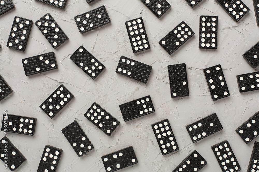 Black domino tiles on concrete background, top view Black domino tiles on concrete background, top view