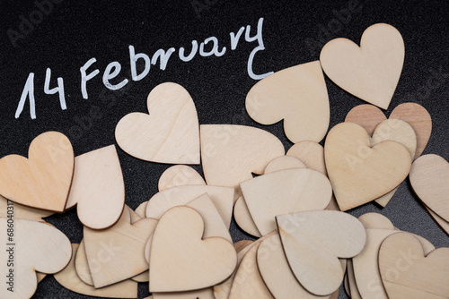 Background with the inscription February 14 and a wooden heart, background for Valentine's Day