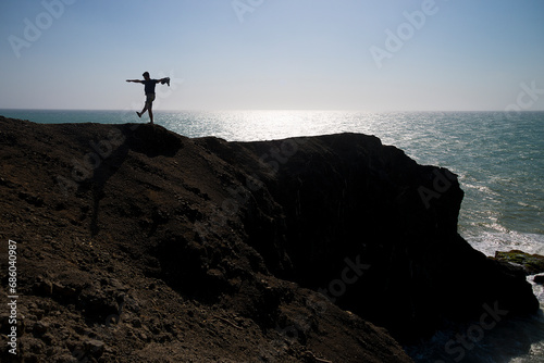 man walking along the rocky coastline of Cabo de la Vela in La Guajira 