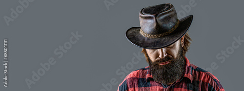 Cowboy Hat. Portrait of young man wearing cowboy hat. Cowboys in hat. Handsome bearded macho. Man unshaven cowboys photo