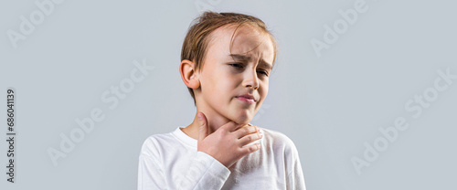 Ill little boy with sore throat. Ill child with sore throat. Sore throats in a child. Child has a sore throats. Signs of a cold in children. Young boy feels that his throat is pain