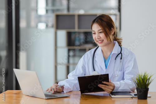 Asian female doctor with patient clipboard at hospital, Medicine and healthcare concept.