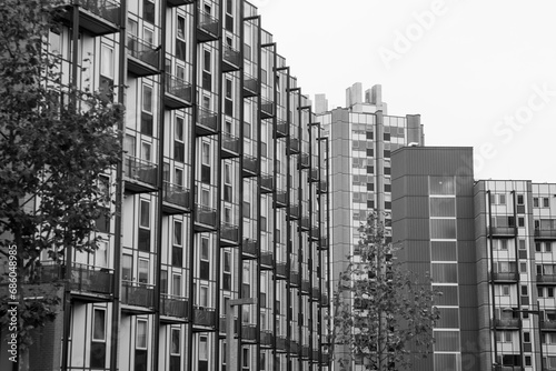 Buildnig with windows,Modern apartment,Black and white photo. A building with balconies on the background