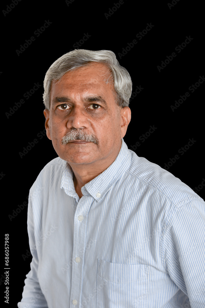 Senior Indian businessman or executive in a light blue shirt Senior Indian businessman or executive in a light blue shirt