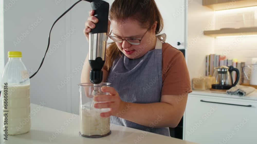 Down syndrome woman baking in domestic kitchen. Shot with RED helium camera in 8K. Down syndrome woman baking in domestic kitchen. Shot with RED helium camera in 8K.
