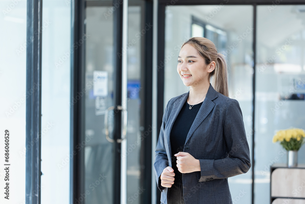 Portrait of Asian businesswoman standing with arms crossed in office workplace. Portrait of Asian businesswoman standing with arms crossed in office workplace.