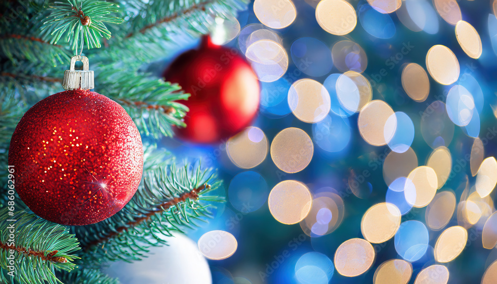 Closeup of red bauble hanging from Christmas tree