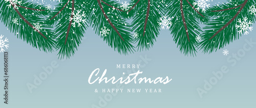 Pale blue New Year and Christmas winter card with green fir branches, snow and snowflakes.