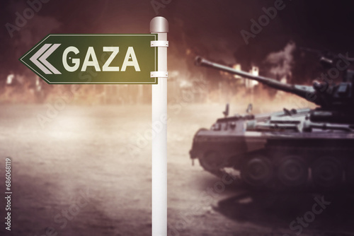 Army tank moving in the war field with in the war field with Gaza word on the signpost