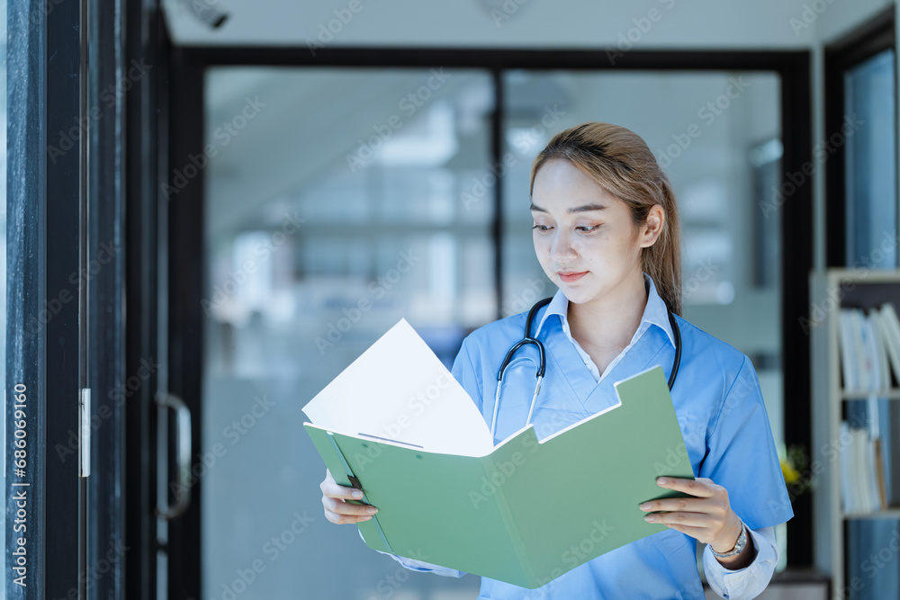 Asian female doctor with patient clipboard at hospital, Medicine and healthcare concept. Asian female doctor with patient clipboard at hospital, Medicine and healthcare concept.