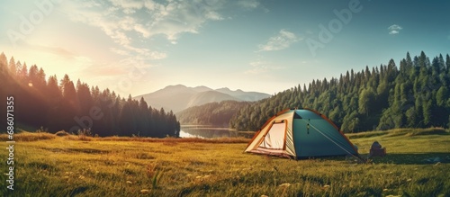 Forest camp with tourist tent amidst meadow Copy space image Place for adding text or design photo