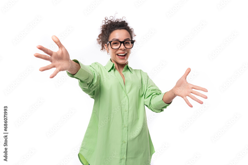 charming young slim female model dressed in a light green shirt waving her hands on a white background with copy space charming young slim female model dressed in a light green shirt waving her hands on a white background with copy space