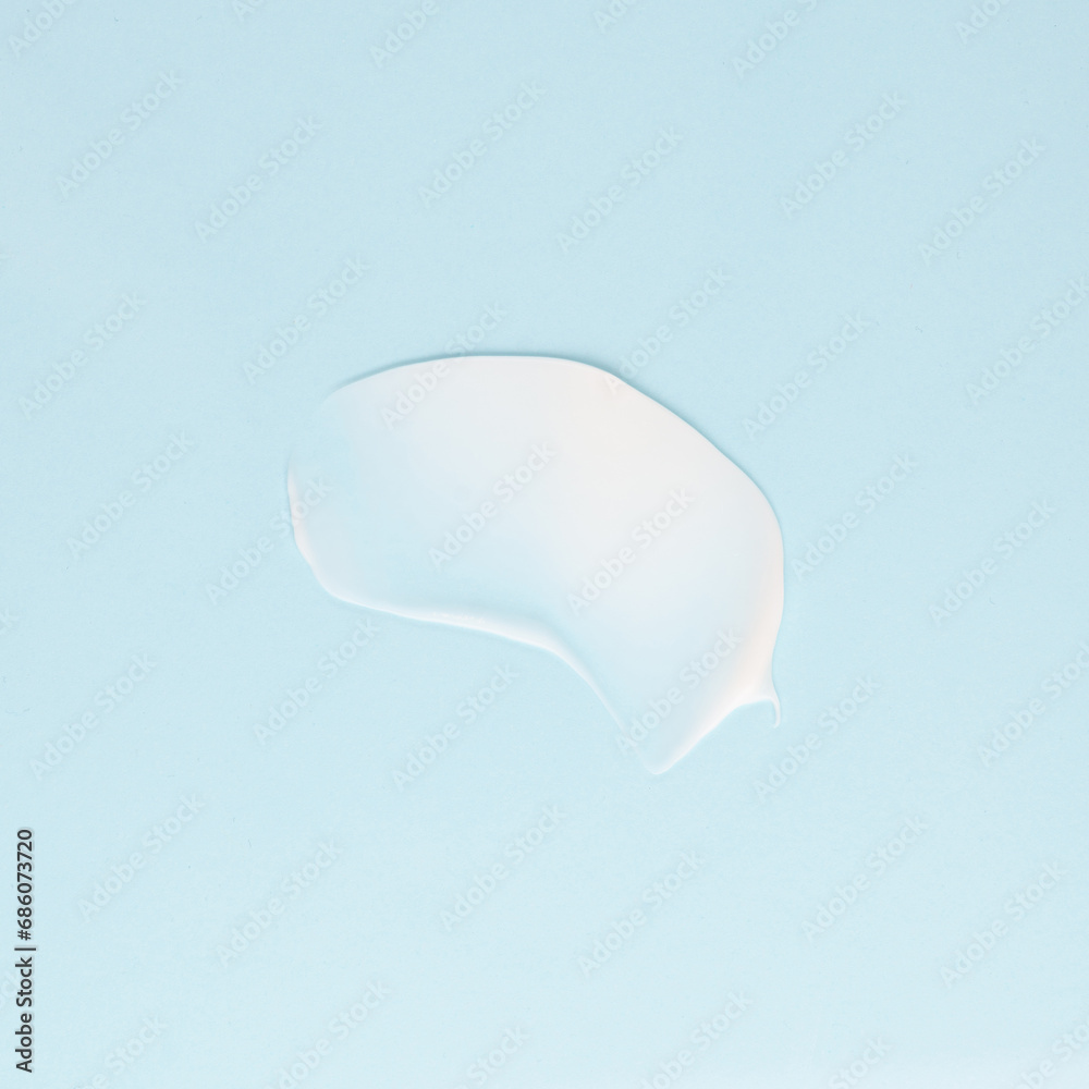 Smear of white cream for face and body on a blue background Smear of white cream for face and body on a blue background