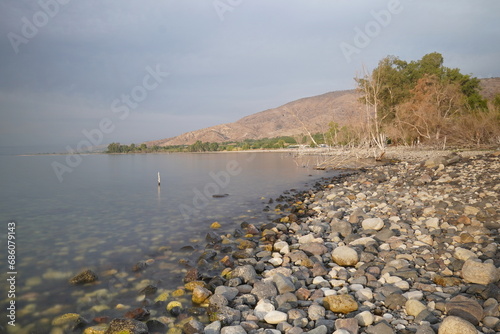 stony beach on the Sea of Galilee in Israel on overcast day
