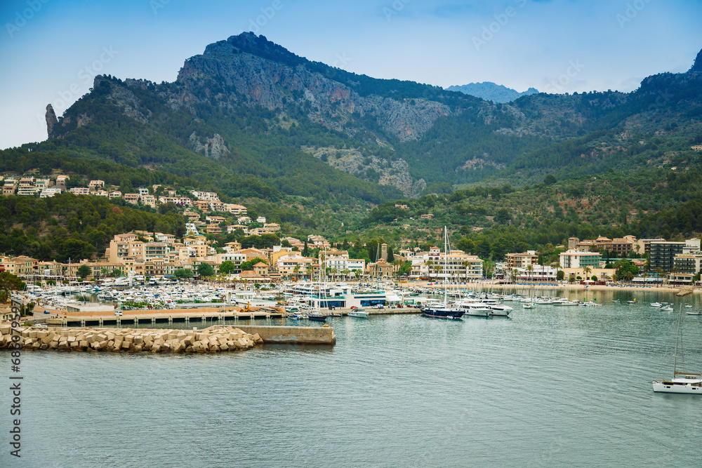 Seaside with boats and yachts in Port de Soller in the evening
