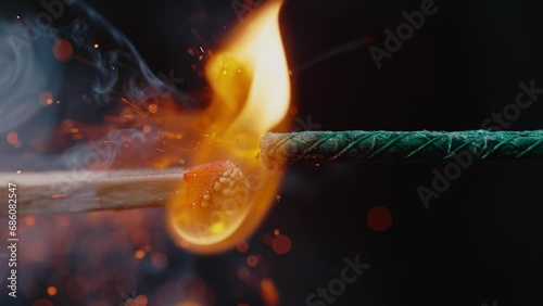 Close-Up View of a Match Lighting a Firework Fuse photo