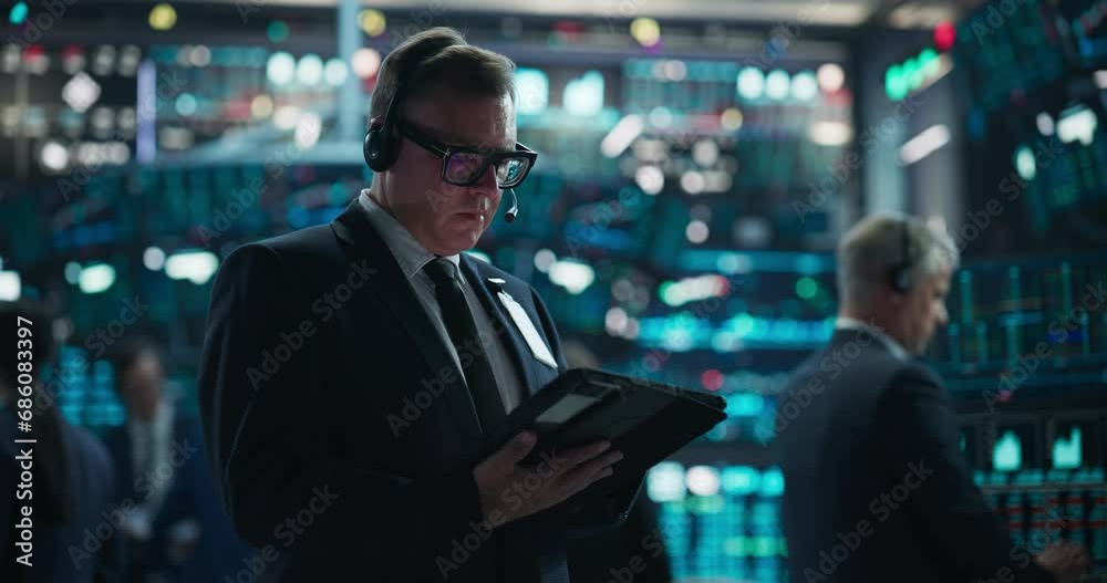 Stock Exchange Investment Trader Using Desktop Computer in a Stock Exchange Agency. Focus Switching to a Team Leader Having a Phone Conversation About Finance, Business, Commodities, Trading Stock Exchange Investment Trader Using Desktop Computer in a Stock Exchange Agency. Focus Switching to a Team Leader Having a Phone Conversation About Finance, Business, Commodities, Trading