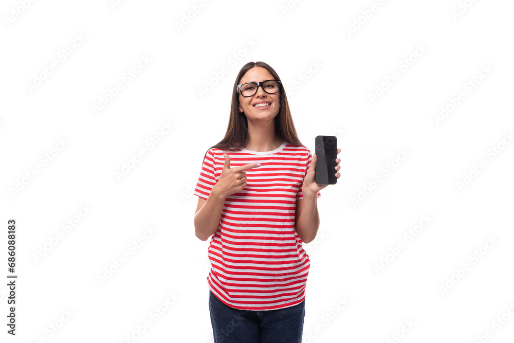 beautiful young caucasian woman with straight hair with glasses and in a striped t-shirt is holding a smartphone mockup. e-business concept beautiful young caucasian woman with straight hair with glasses and in a striped t-shirt is holding a smartphone mockup. e-business concept