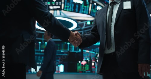 Two Corporate Business Partners Agree on Successful Deal, Shake Hand in Office. Banker and International Company Representative Collaborate on Lucrative Investment Opportunity. Anonymous Businessmen