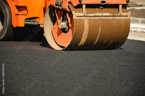 road roller rolls asphalt
