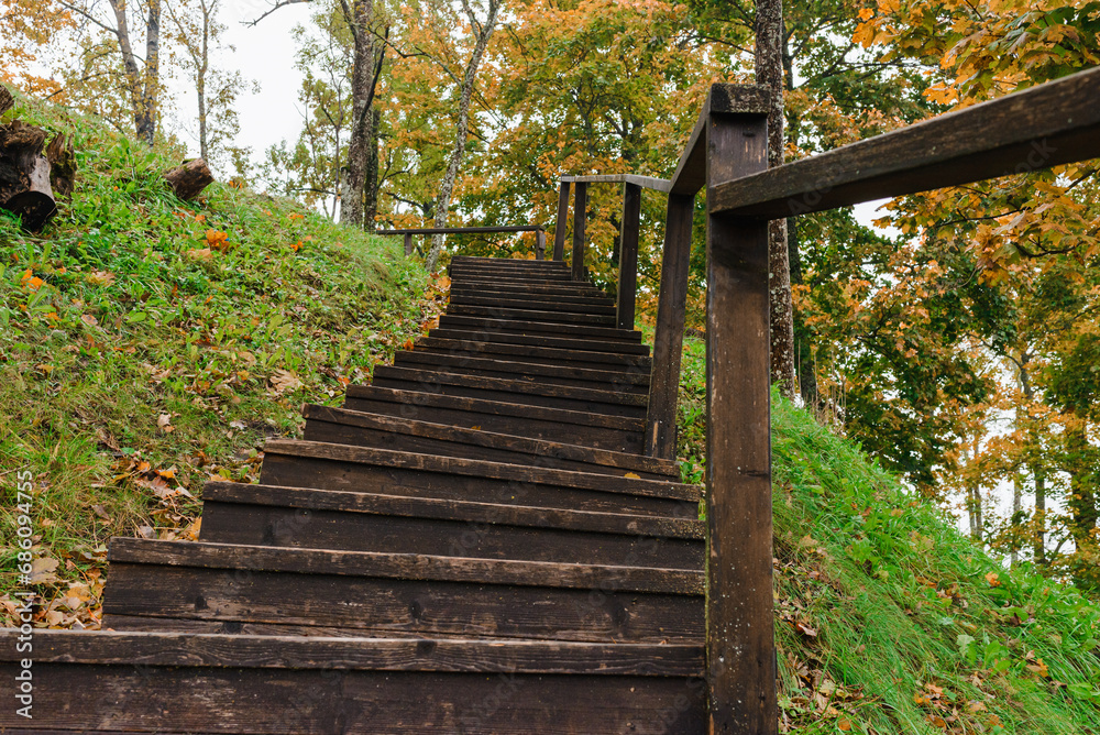 The boardwalk and stairs.Wooden stairs for climbing the mountain. Wooden stairs high in the mountains.Selective focus. The boardwalk and stairs.Wooden stairs for climbing the mountain. Wooden stairs high in the mountains.Selective focus.