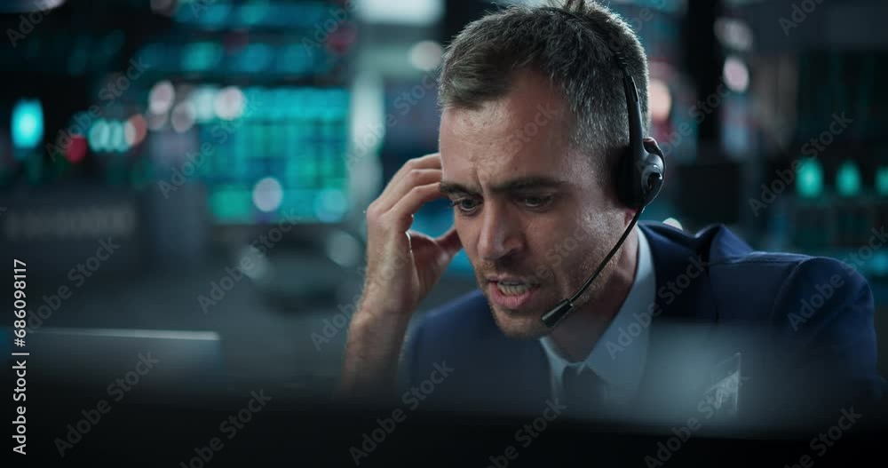 Portrait of a Financial Analyst Using a Desktop Computer with Real-Time Graphs, Financial Reports and Market Updates. Trader Working in a Modern Stock Exchange and Communicating with Brokers