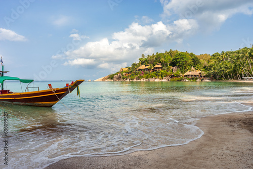 Boat on empty calm sandy tropical Sairee beach in the morning on Koh Tao island in Thailand. Picturesque peaceful calmness coastline © evgenydrablenkov
