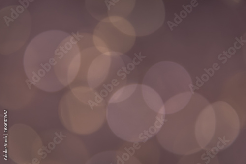 Bokeh on the brown background. Abstract bokeh on a dark background. Abstract christmas background with bokeh. Abstract background with bokeh.