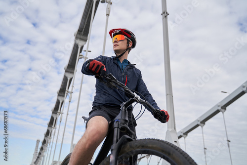 Portrait of a cyclist man against the background of the city.
