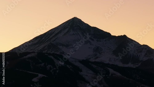 Cinematic drone shot of lone mountain peak at sunset in Montana photo