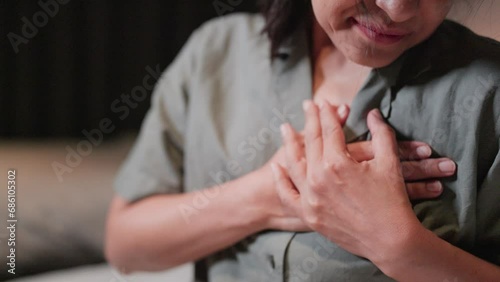 Woman feels pain when touching her chest, has a heart attack and is worried, suffers from myocardial infarction or heart disease. Woman photo