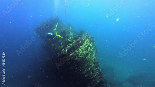 Scuba divers and the sunken ship wreck photo