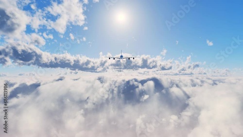 An unbranded commercial airplane flying toward the camera above the clouds on a beautiful summer day. photo