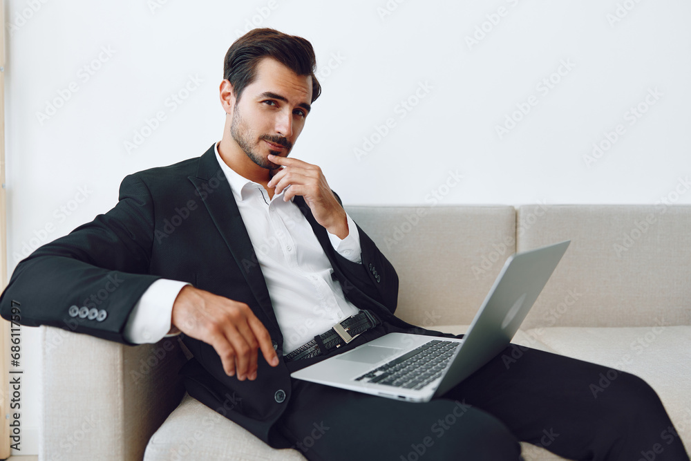 Man working notebook sofa office sitting freelance laptop job video call suit using businessman Man working notebook sofa office sitting freelance laptop job video call suit using businessman