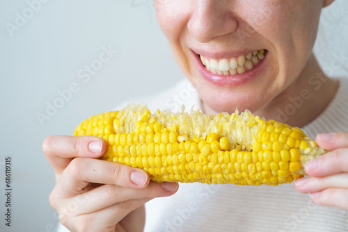 Obraz na płótnie Close up an unrecognizable biting boiled corn
