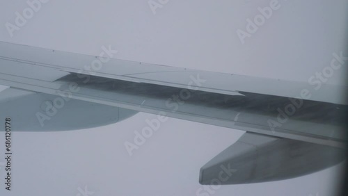 Turbulent Flight with Snow and Rain: Adverse Weather Conditions During Air Travel in 4k slow motion 60fps