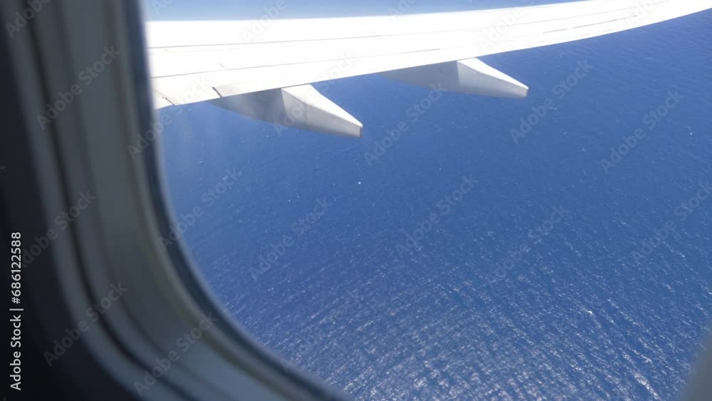 Breathtaking Aerial View of the Ocean Below Through an Airplane Window in 4k slow motion 60fps Breathtaking Aerial View of the Ocean Below Through an Airplane Window in 4k slow motion 60fps