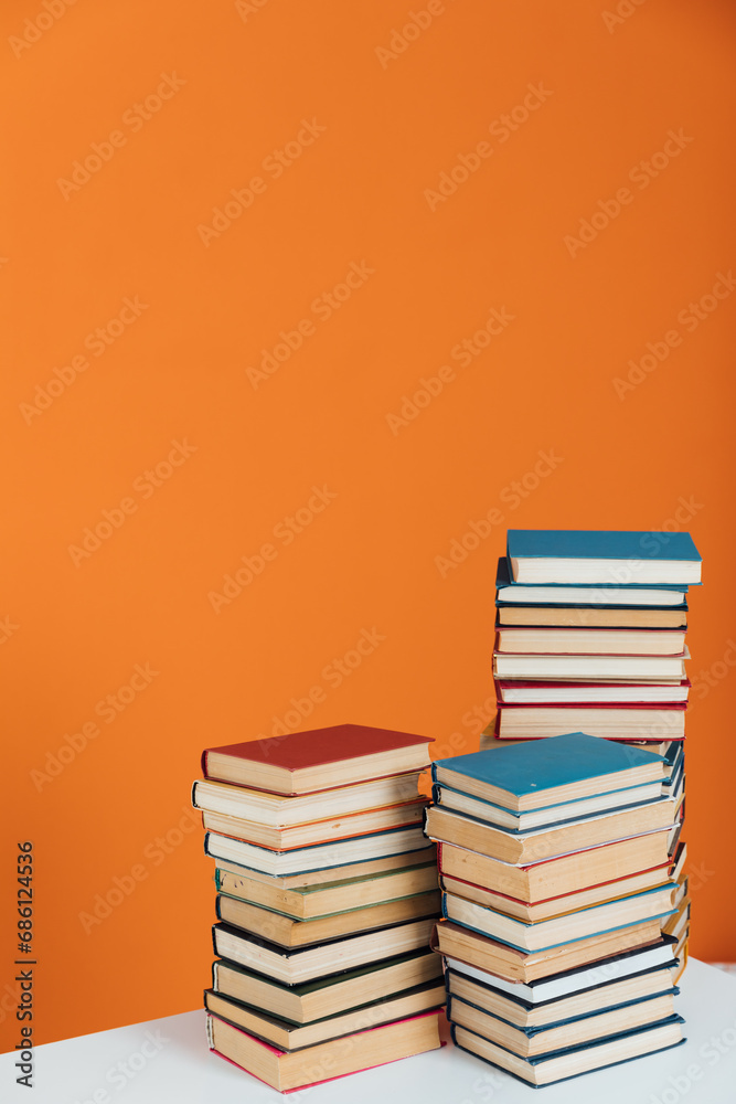 Many Books Piles. Hardback books on wooden table. Back to school.