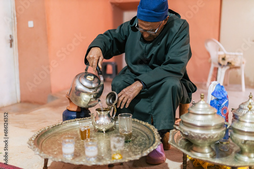 Man pouring water from kettle while making tea