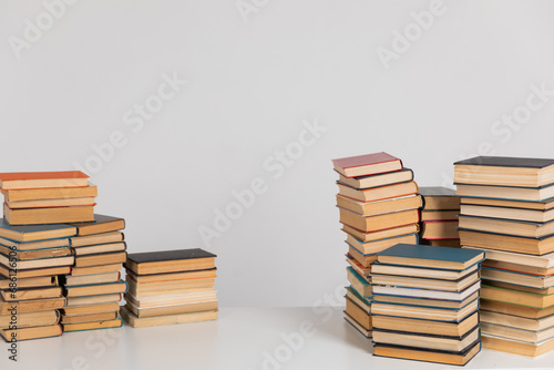 Lots of stacks of old educational books on white background university school library