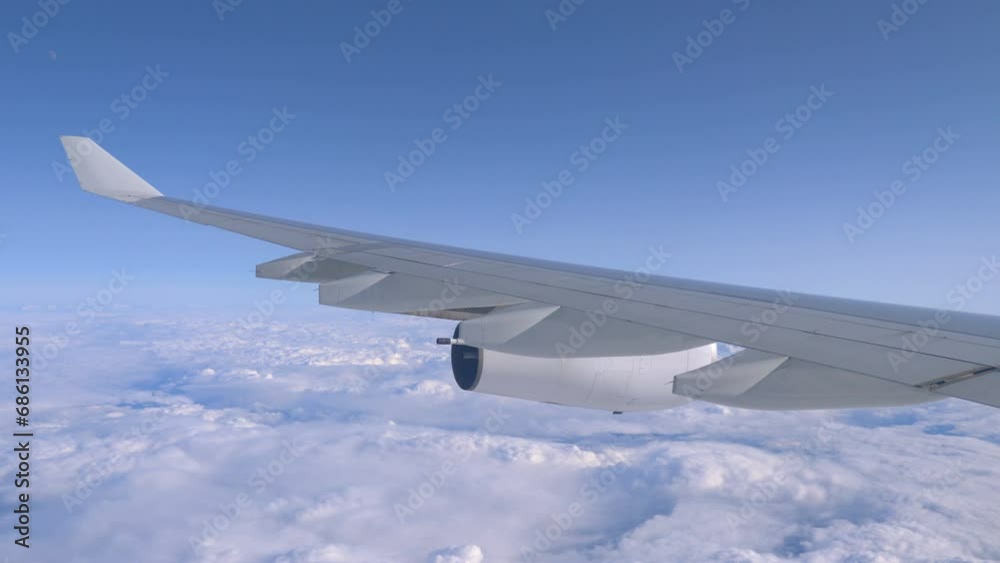 Aerial View of an Airplane Flying High Above the Clouds in 4k Aerial View of an Airplane Flying High Above the Clouds in 4k