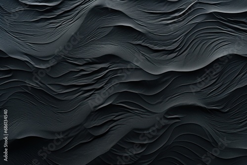  a close up of a black surface with wavy, wavy, wavy, wavy, wavy patterns on the surface.