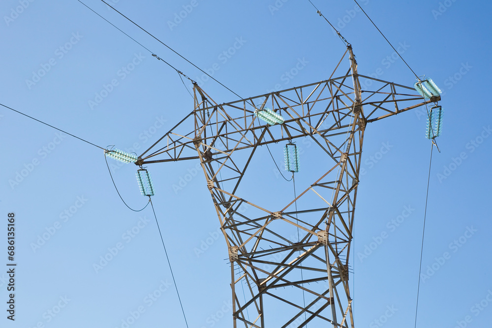 Power tower and transmission lines on blue background Power tower and transmission lines on blue background