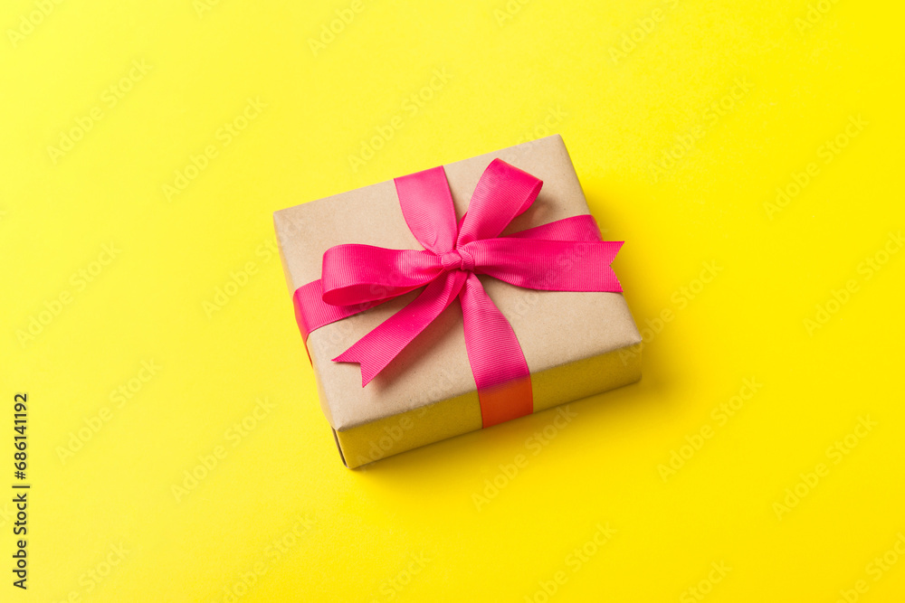 Wrapped christmas or other holiday handmade present in craft paper with colored ribbon. Present box, decoration of gift on table, top view with copy space Wrapped christmas or other holiday handmade present in craft paper with colored ribbon. Present box, decoration of gift on table, top view with copy space