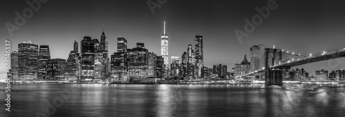 Panoramic view of New York City Lower Manhattan skyscrapers at twilight with the Brooklyn Bridge and East River (Black and White)